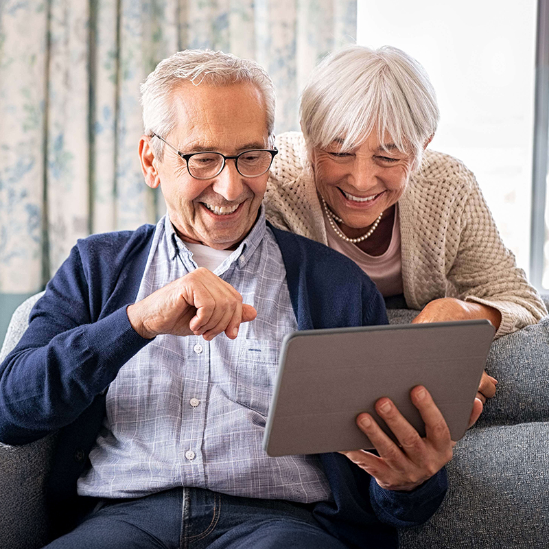 Happy senior couple using tablet.