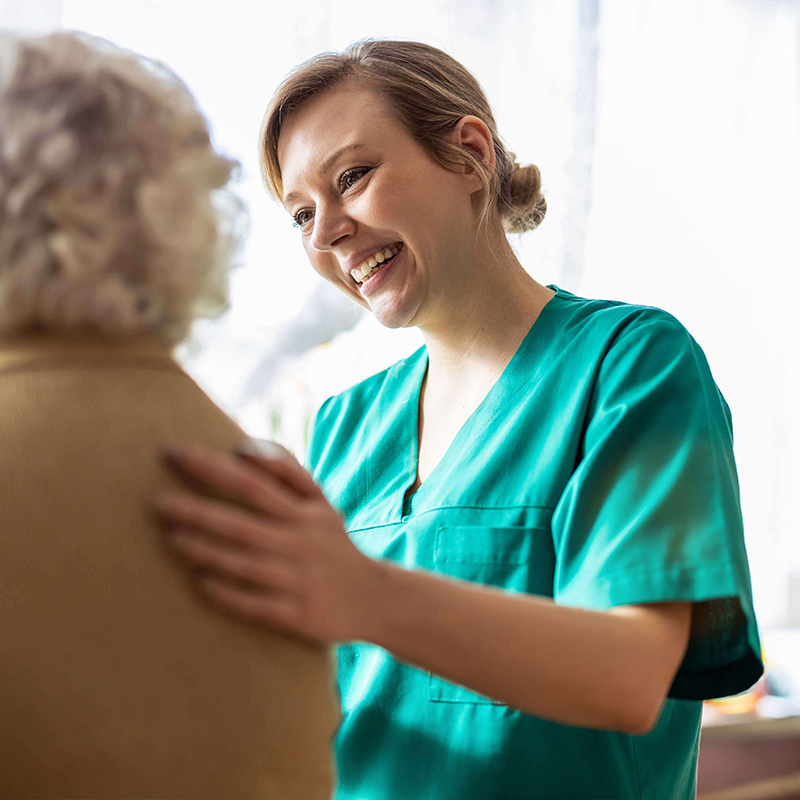 Smiling clinician comforting woman.
