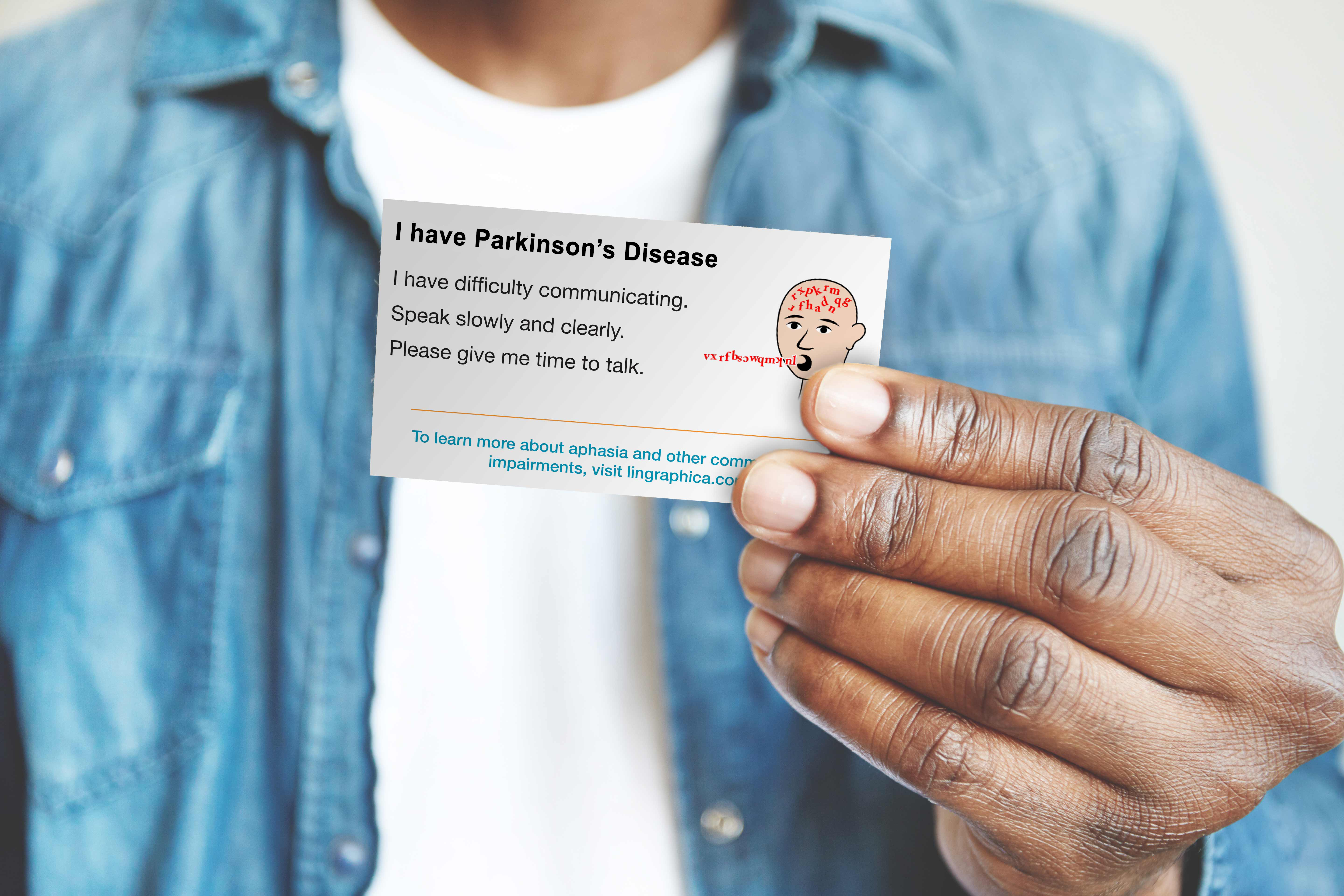 Image of man holding a Parkinson's communication ID card