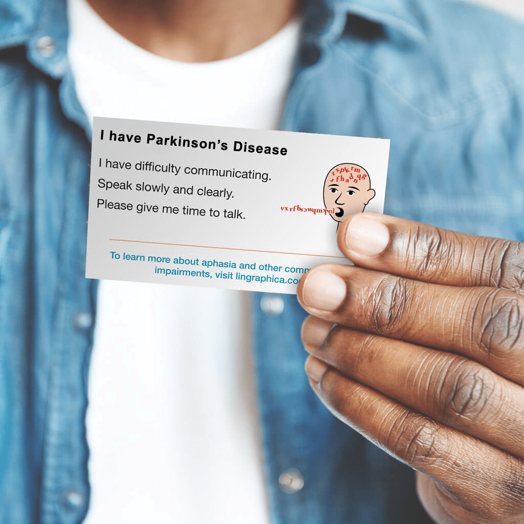 Image of man holding a personalized Parkinson's communication ID card