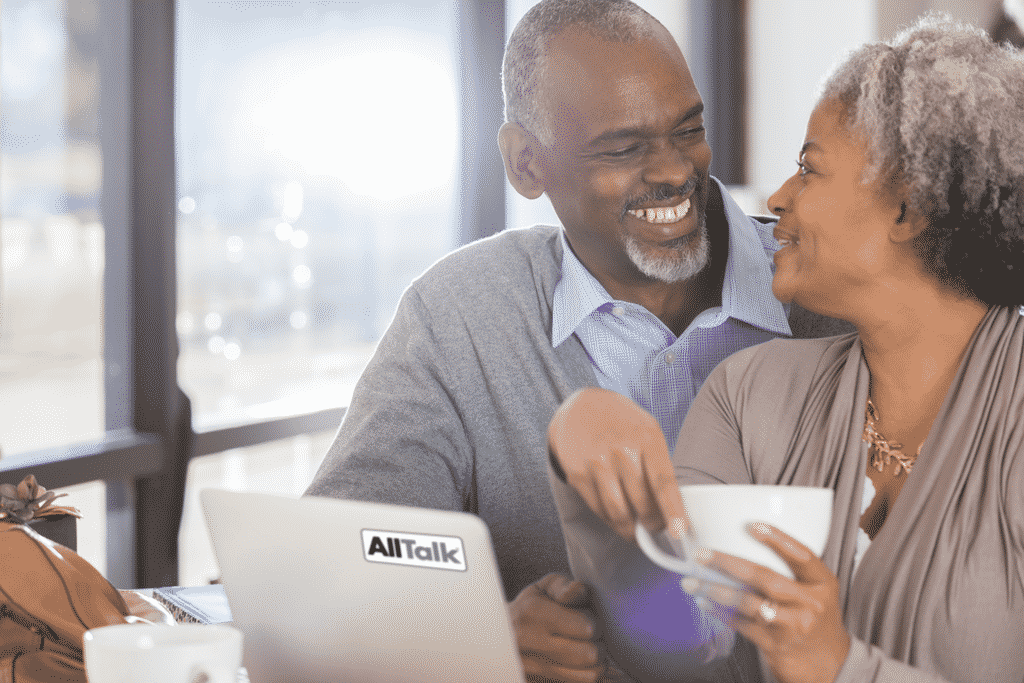 Couple using an AllTalk while drinking coffee