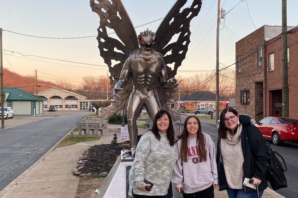 Alyssa, her mom, and her friend in front of the Mothman statue