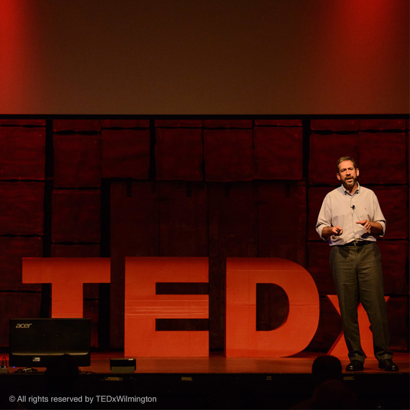 Photo of Andrew Gomory, CEO of Lingraphica in 2013, giving his talk on the TEDxWilmington stage.