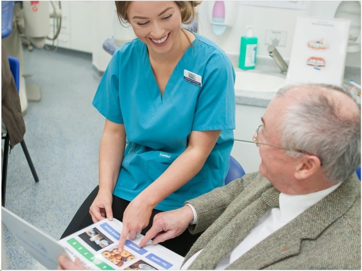 Elderly man using an AAC communication board
