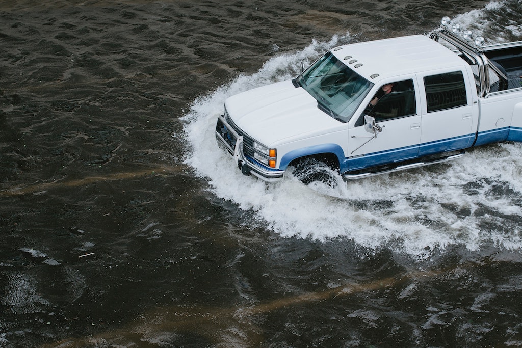 truck driving through flood