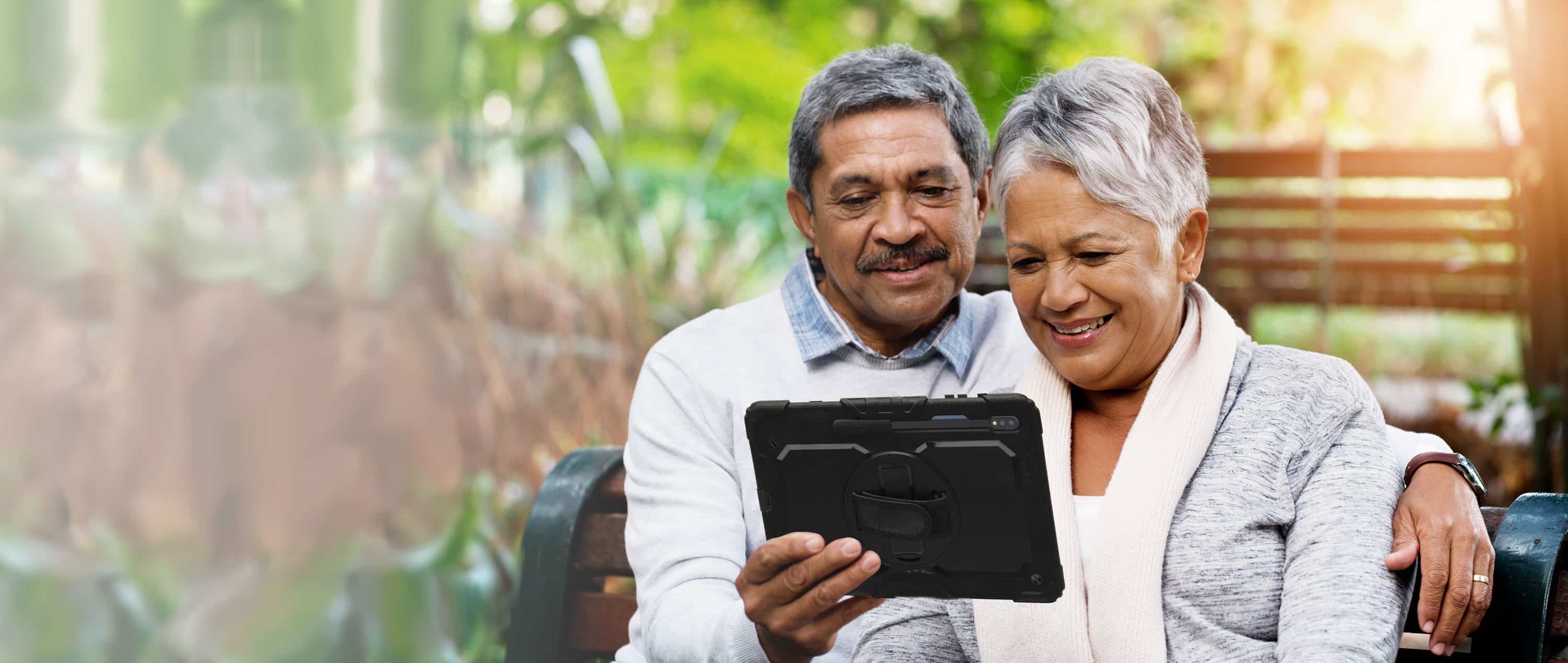 Couple sitting on bench with AAC device